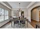 Dining room features an elegant chandelier, neutral walls, hardwood floors, and modern decor at 2633 Hanriva Ct, Dacula, GA 30019