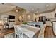 Open concept kitchen and dining area with white cabinets, a kitchen island, and wicker chairs at 2633 Hanriva Ct, Dacula, GA 30019