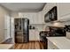 Modern kitchen with stainless steel refrigerator and gas range at 2633 Hanriva Ct, Dacula, GA 30019