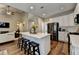 Open-concept kitchen with a large island, stainless steel appliances, and seamless flow to the living area at 2633 Hanriva Ct, Dacula, GA 30019