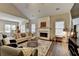 Open concept living room features a fireplace, hardwood floors, and lots of natural light at 2633 Hanriva Ct, Dacula, GA 30019