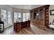 Bright home office with ample natural light, hardwood floors, and custom built-in shelving at 2633 Hanriva Ct, Dacula, GA 30019