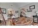 Office featuring a patterned wood table, archways to other rooms, and staircase in view at 2633 Hanriva Ct, Dacula, GA 30019