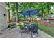 Outdoor patio with a table, chairs, and a hanging chair, surrounded by lush greenery at 2633 Hanriva Ct, Dacula, GA 30019