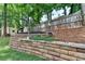 Backyard landscaping with a stone retaining wall, adding texture and dimension to the outdoor space at 2633 Hanriva Ct, Dacula, GA 30019