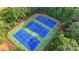 A set of pristine tennis courts nestled in a lush, green environment, perfect for active recreation and sports at 2633 Hanriva Ct, Dacula, GA 30019