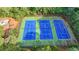 Aerial view showcasing three well-maintained tennis courts, ready for recreational activities amidst lush greenery at 2633 Hanriva Ct, Dacula, GA 30019