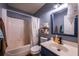 Compact bathroom with tub-shower combo, updated vanity, and stylish blue accents for a modern feel at 305 Saddle Wood Dr, Canton, GA 30114