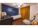 Cozy bedroom features a single bed, wood floors, and a bright yellow curtain at 305 Saddle Wood Dr, Canton, GA 30114