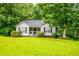 Charming single-story home with lush lawn and mature trees at 305 Saddle Wood Dr, Canton, GA 30114