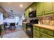 Eat-in kitchen featuring light green cabinets and modern appliances at 305 Saddle Wood Dr, Canton, GA 30114