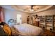 Bright main bedroom with tray ceiling, ensuite, and walk-in closet, complete with modern ceiling fan at 305 Saddle Wood Dr, Canton, GA 30114