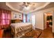 Spacious main bedroom boasts tray ceiling, ensuite bathroom, and walk-in closet access at 305 Saddle Wood Dr, Canton, GA 30114