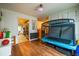 Spacious play area with laminate flooring, neutral paint, and educational wall decor, plus doorway view to kitchen at 305 Saddle Wood Dr, Canton, GA 30114