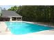 Community swimming pool with fencing, seating, and a bright blue water surface at 305 Saddle Wood Dr, Canton, GA 30114