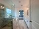 Bright bathroom with a glass shower, garden tub, double vanity, and views to the main bedroom at 532 Healy Dr # 61, Cumming, GA 30040