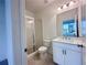 Modern bathroom with glass-enclosed shower, vanity, and elegant lighting fixtures and white tile at 532 Healy Dr # 61, Cumming, GA 30040