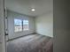 Carpeted bedroom with a window offering natural light and neighborhood views; freshly painted and ready at 532 Healy Dr # 61, Cumming, GA 30040