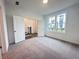 Well-lit bedroom featuring neutral carpet and double doors, offering versatile living space at 532 Healy Dr # 61, Cumming, GA 30040