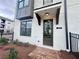 Attractive townhome featuring a brick entryway, stylish door, and coordinated exterior details at 532 Healy Dr # 61, Cumming, GA 30040