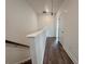 Upper hallway featuring wood-look floors leading to various rooms in the home's upper level at 532 Healy Dr # 61, Cumming, GA 30040