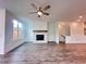 Comfortable living room includes a decorative fireplace, ceiling fan, and generous natural light at 532 Healy Dr # 61, Cumming, GA 30040