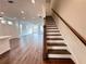 Elegant staircase leading to the upper level, adjacent to the kitchen and living areas at 532 Healy Dr # 61, Cumming, GA 30040