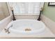 Oval soaking tub with tile surround, decorative candles, and nearby glass shower at 730 Jackson Miller Cir, Powder Springs, GA 30127