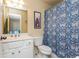 Well-lit bathroom featuring a vanity, toilet, and shower with a patterned curtain at 730 Jackson Miller Cir, Powder Springs, GA 30127
