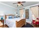 Bright and airy bedroom with a wooden bed frame and hardwood floors at 730 Jackson Miller Cir, Powder Springs, GA 30127