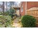 Back exterior view showing a well-maintained brick home with a deck, and landscaped pathway at 730 Jackson Miller Cir, Powder Springs, GA 30127