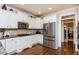 Modern kitchen with stainless steel appliances, granite countertops, and white cabinets at 730 Jackson Miller Cir, Powder Springs, GA 30127