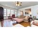 Sun-filled living room with hardwood floors, comfortable sofa, and access to the backyard at 730 Jackson Miller Cir, Powder Springs, GA 30127