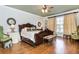 Spacious bedroom features hardwood floors, detailed ceiling and comfortable seating at 730 Jackson Miller Cir, Powder Springs, GA 30127