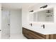 Bathroom with double vanity, illuminated mirrors, glass shower, and modern fixtures at 2380 Greenglade Ne Rd, Atlanta, GA 30345