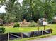 Future home construction site with Coming Soon sign nestled among trees in a lush, green lawn at 2380 Greenglade Ne Rd, Atlanta, GA 30345