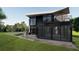 Modern two-story home features a covered porch, exterior patio, and an upper level balcony at 2380 Greenglade Ne Rd, Atlanta, GA 30345