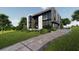 Modern home exterior featuring clean lines, large windows, and a beautifully landscaped front yard at 2380 Greenglade Ne Rd, Atlanta, GA 30345