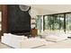 Modern living room with a fireplace, sleek couches, and floor-to-ceiling windows at 2380 Greenglade Ne Rd, Atlanta, GA 30345