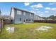 Large, blue two-story home backyard with green grass and wood fence at 3699 Broadwick Ln, Lithonia, GA 30038