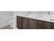 Bathroom vanity with dual sinks, quartz countertops, and dark brown cabinetry at 3699 Broadwick Ln, Lithonia, GA 30038