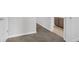 Hallway with carpeted floors leading to bathroom with cabinetry and tile flooring at 3699 Broadwick Ln, Lithonia, GA 30038