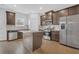 Bright kitchen features stainless steel appliances, granite counters, and island for extra space at 3699 Broadwick Ln, Lithonia, GA 30038