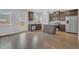 Bright kitchen features stainless steel appliances, an island with granite counters, and wood floors at 3699 Broadwick Ln, Lithonia, GA 30038
