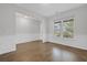 Bright living room with hardwood floors, wainscoting, and a large window overlooking the yard at 3699 Broadwick Ln, Lithonia, GA 30038