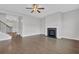 Inviting living room with hardwood floors, a cozy fireplace, and staircase on the left at 3699 Broadwick Ln, Lithonia, GA 30038