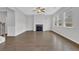 Expansive living room with a fireplace, hardwood floors, large windows, and fresh paint at 3699 Broadwick Ln, Lithonia, GA 30038