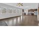 Open-concept living space featuring hardwood floors, a ceiling fan, and a modern kitchen at 3699 Broadwick Ln, Lithonia, GA 30038