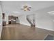 Large open living area boasting hardwood floors, modern lighting, and a view of the staircase at 3699 Broadwick Ln, Lithonia, GA 30038