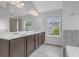 Bright main bathroom featuring dual vanity, a soaking tub and windows at 3699 Broadwick Ln, Lithonia, GA 30038